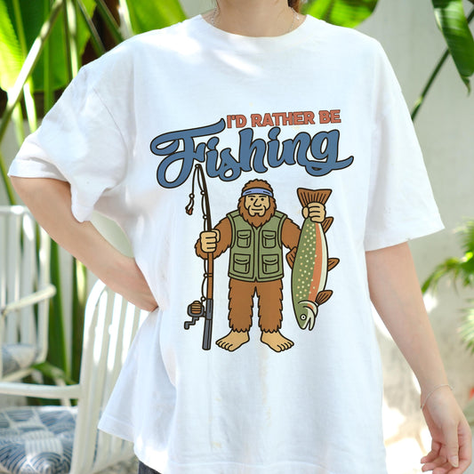 I'd Rather Be Fishing Bigfoot Shirt, Funny Fisherman Tee for Men, Sasquatch Holding Fish Graphic T-shirt, Outdoors Lake Fishing Gift